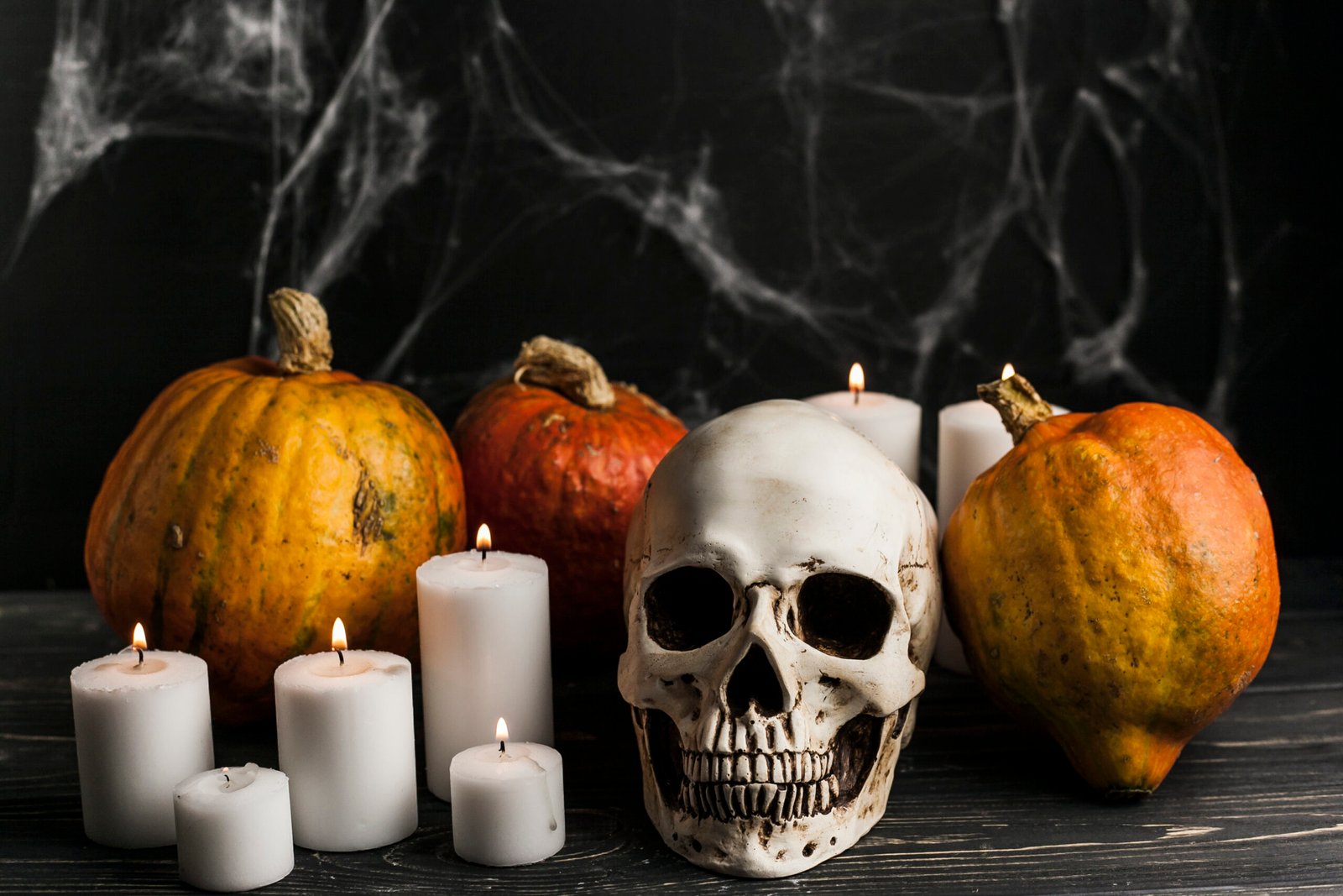 Halloween mantel decorated with candles and skulls scaled
